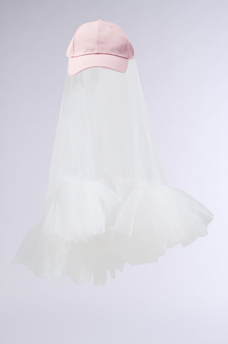 The CITY NIGHTS VEILED HAT combines a whimsical AKIRA Label light pink baseball cap with billowing, ghost-like white transparent mesh for a playful and ethereal look. 3