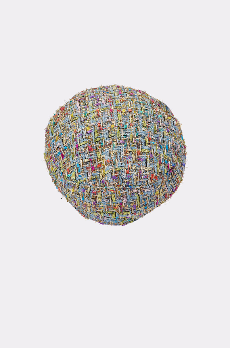 The I HAVE CLASS TWEED BRIM HAT is a round, multicolored newsboy cap featuring a textured pattern and a subtle gold chain trim, shown on a plain white background. 4