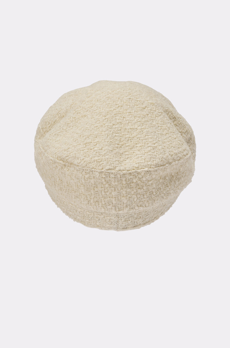 The IN MALLORCA TWEED BRIM HAT is an off-white boucle brimmed hat with textured fabric and chic chain-link detailing, shown against a plain white background. 5