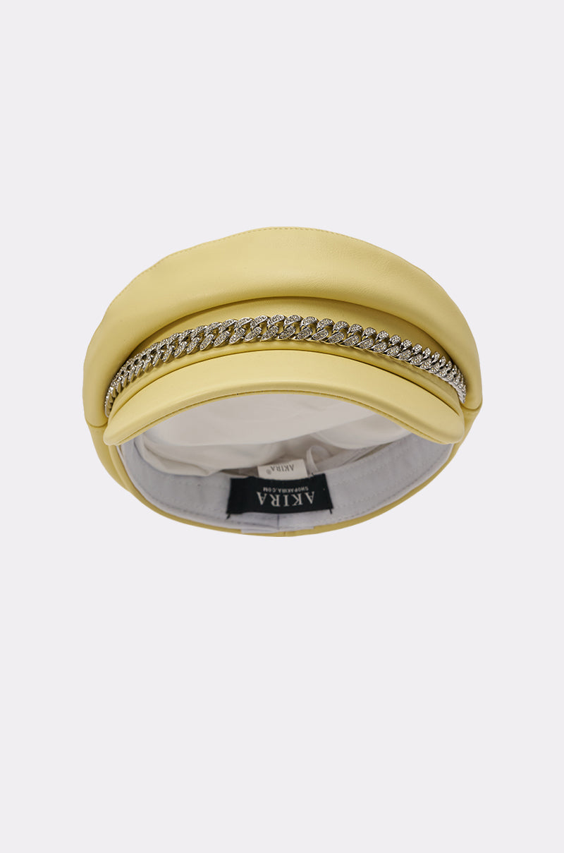 The BUTTER ME UP PU BRIM HAT features a butter yellow padded design with a row of sparkling rhinestones on top, a white fabric lining, and the "AKIRA" brand label inside for added rhinestone chain hat-inspired glamour. 3