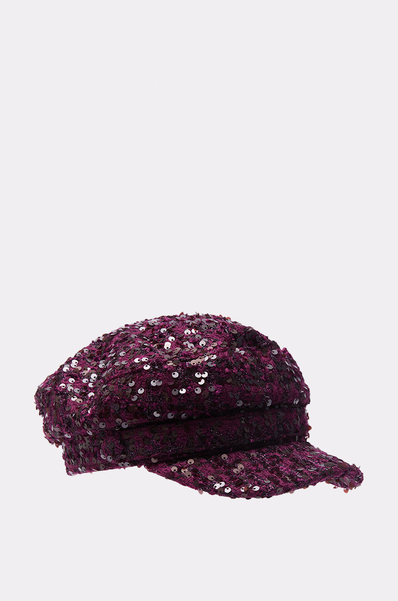The KARY TWEED HAT, a dark purple baker boy style adorned with shiny sequin embellishments, is shown against a plain light background. 4