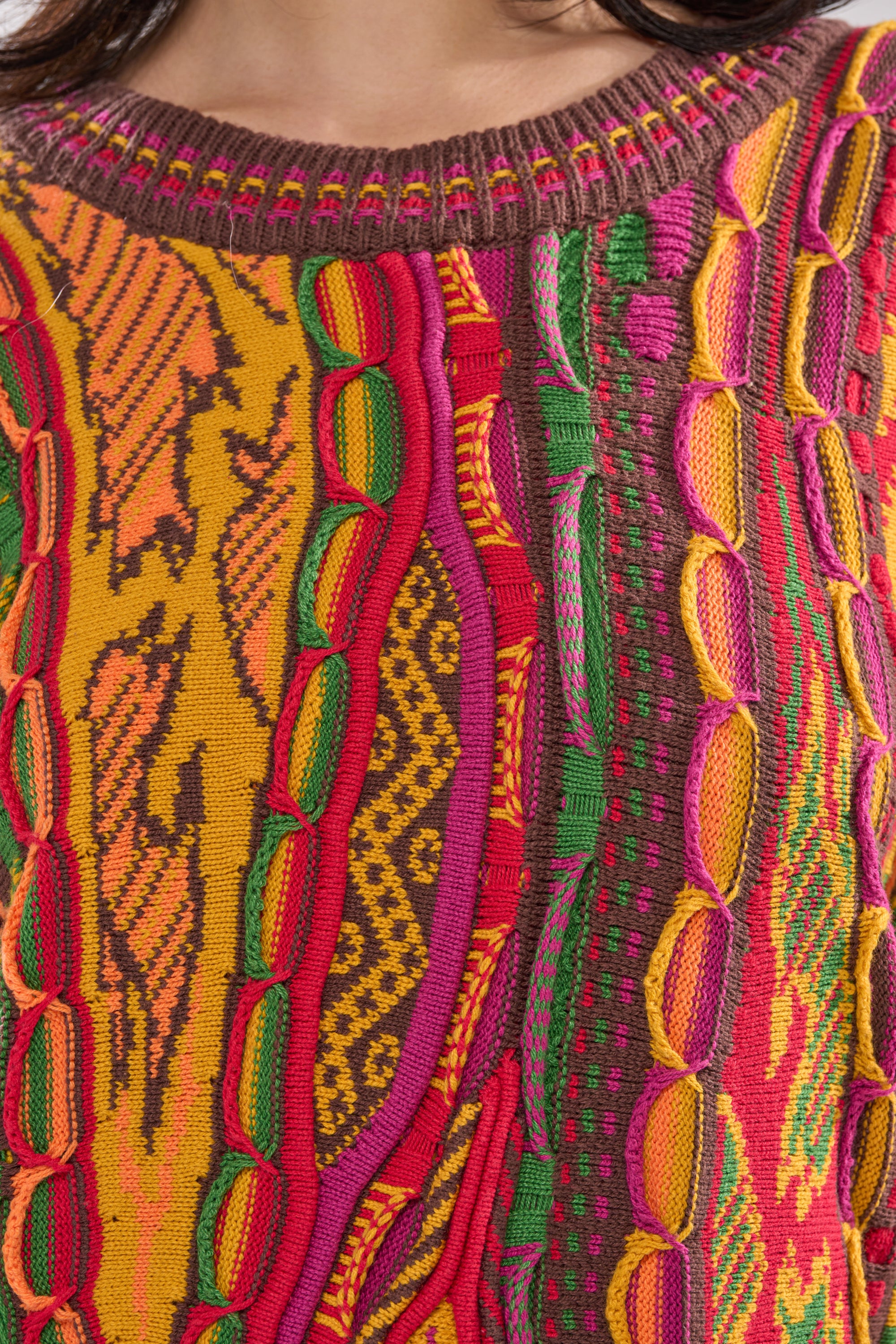 A close-up of the THROWBACK SPECIAL KNIT SWEATER highlights its vibrant colors and unique retro-inspired knit details. 5