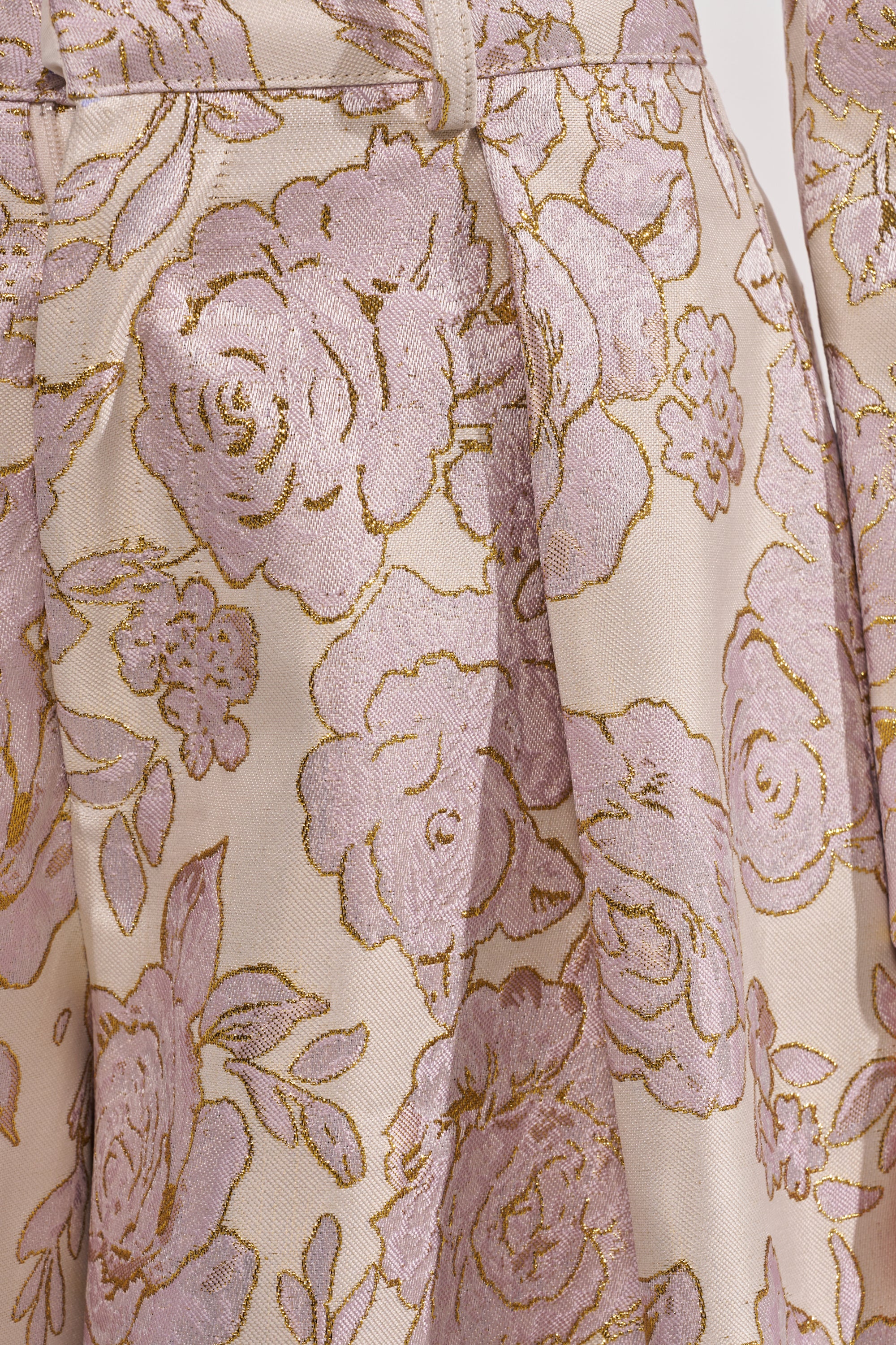 Close-up of CHERI BROCADE WIDE LEG PANT fabric—light pink with gold floral brocade, detailed rose and leaf patterns, and metallic gold accents—ideal for creating striking wide-leg trousers or statement metallic floral pants. 9