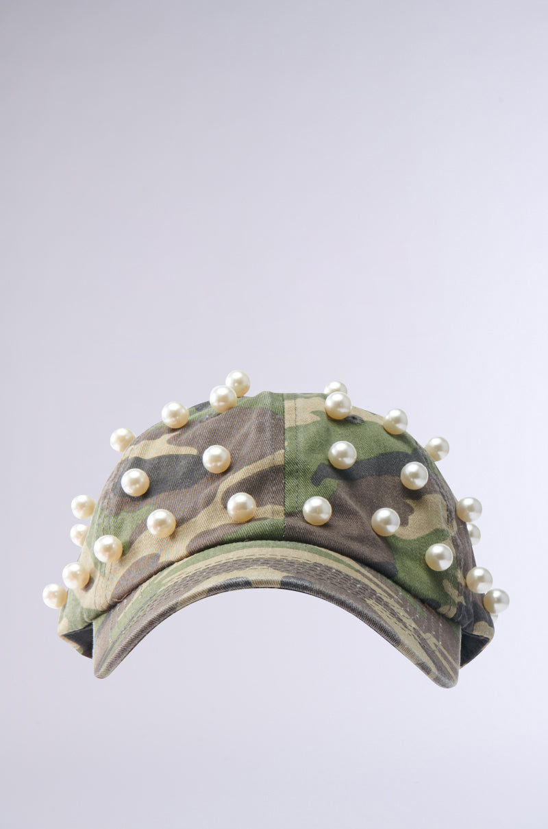 The PEARL PLEASE CAMO HAT features evenly spaced pearl embellishments on the front and brim, displayed against a plain light gray background. 2