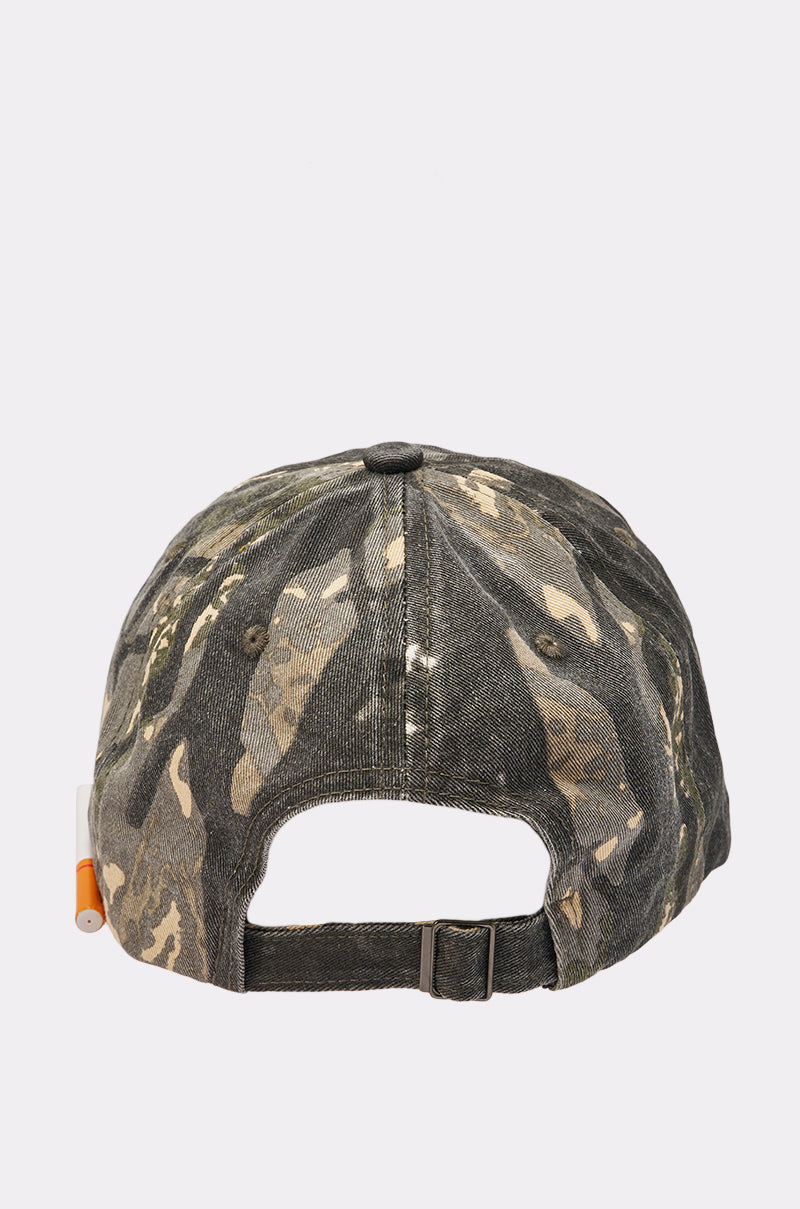The LIGHT IT UP FAUX CIG HAT is a camo print baseball cap seen from the back, with an adjustable strap and a small orange tag on the left—a standout street style accessory. 6