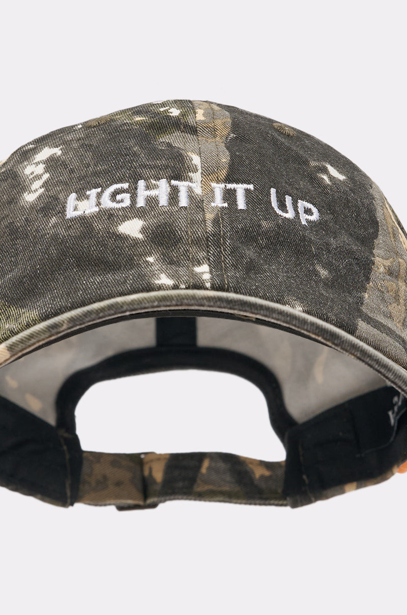 The LIGHT IT UP FAUX CIG HAT is a camo print baseball cap with white “LIGHT IT UP” embroidery on the front and an adjustable strap at the back—a bold street style accessory for any casual outfit. 7