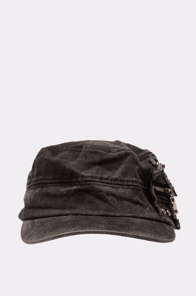 The I REALLY DO THIS HAT is a black, military-inspired cap with a slightly worn texture, detailed with decorative metal zippers and rivets on the right side, shown against a plain light background. 2