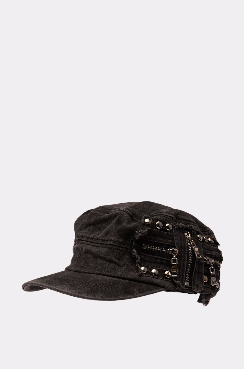The "I REALLY DO THIS HAT" is a black military-inspired cap featuring metal studs, zippers, and a side pocket, showcased against a plain light background for a punk-rock vibe. 3