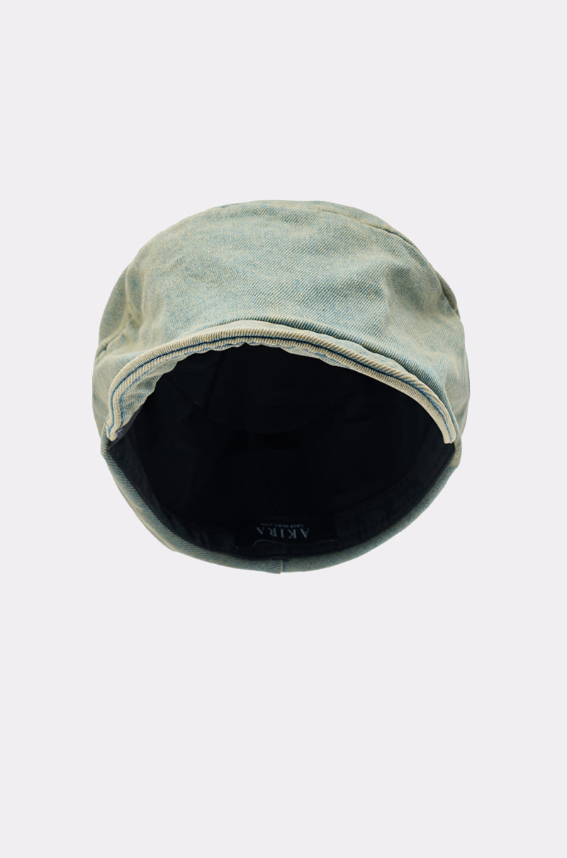 A top-down view of the IT GURL SLOUCH DENIM HAT, featuring light-colored, slightly worn denim and a dark interior lining, shown on a plain light gray background.
