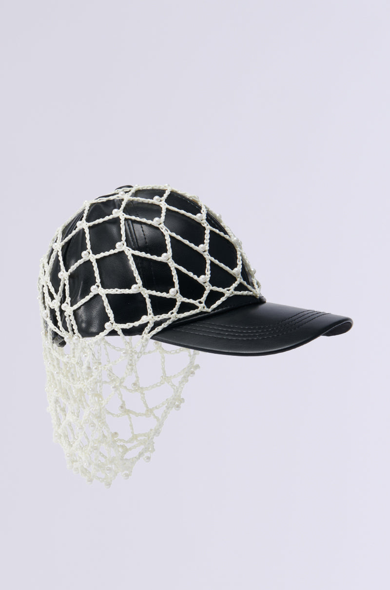 The 'CATCH ME IF YOU CAN HAT' features a black faux leather baseball cap, uniquely designed with a white rope fishnet overlay that has a checkered pattern. The netting elegantly drapes over the sides and back of the cap, set against a plain light gray background. 3