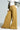 A person poses wearing the GIVE IT TO ME LOW RISE DENIM PANT, showcasing a stylish, flared silhouette along with a cropped jacket featuring white fur trim. The outfit exudes contemporary flair, with the upper body and head cropped out of the image.