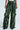 Person wearing the RUNNIN WILD CARGO PANT in a sleek green and black snakeskin pattern, featuring multiple pockets and button details. These faux leather pants boast a shiny, textured surface for a bold look.