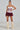 A model confidently poses in the VARSITY SQUAD BUBBLE MINI SKIRT, featuring a white and maroon design with 
