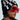 Wearing oversized red sunglasses and a black I REALLY DO BEANIE adorned with "I ❤️ ME" badges, a person completes their look with a black and white striped jacket. The side profile image showcases the beanie's stretchy knit, adding coziness to this statement ensemble.