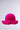 The CROCHET NIGHTS HAT, in bright pink with a round crown and wide ruffled brim, is beautifully crochet knit and displayed against a plain light gray background.