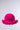 The CROCHET NIGHTS HAT features a vibrant pink crochet knit and a ruffled brim, showcased against a plain light gray background.