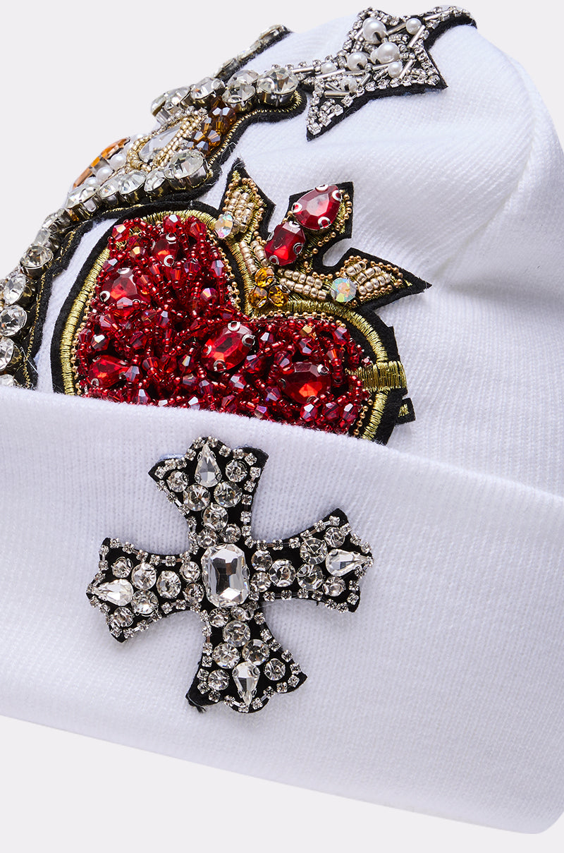 Make a statement with the NO ONE ELSE LIKE ME BEANIE—a white beanie adorned with sparkling rhinestones, a bold red jeweled heart, and eye-catching silver jeweled crosses. 6