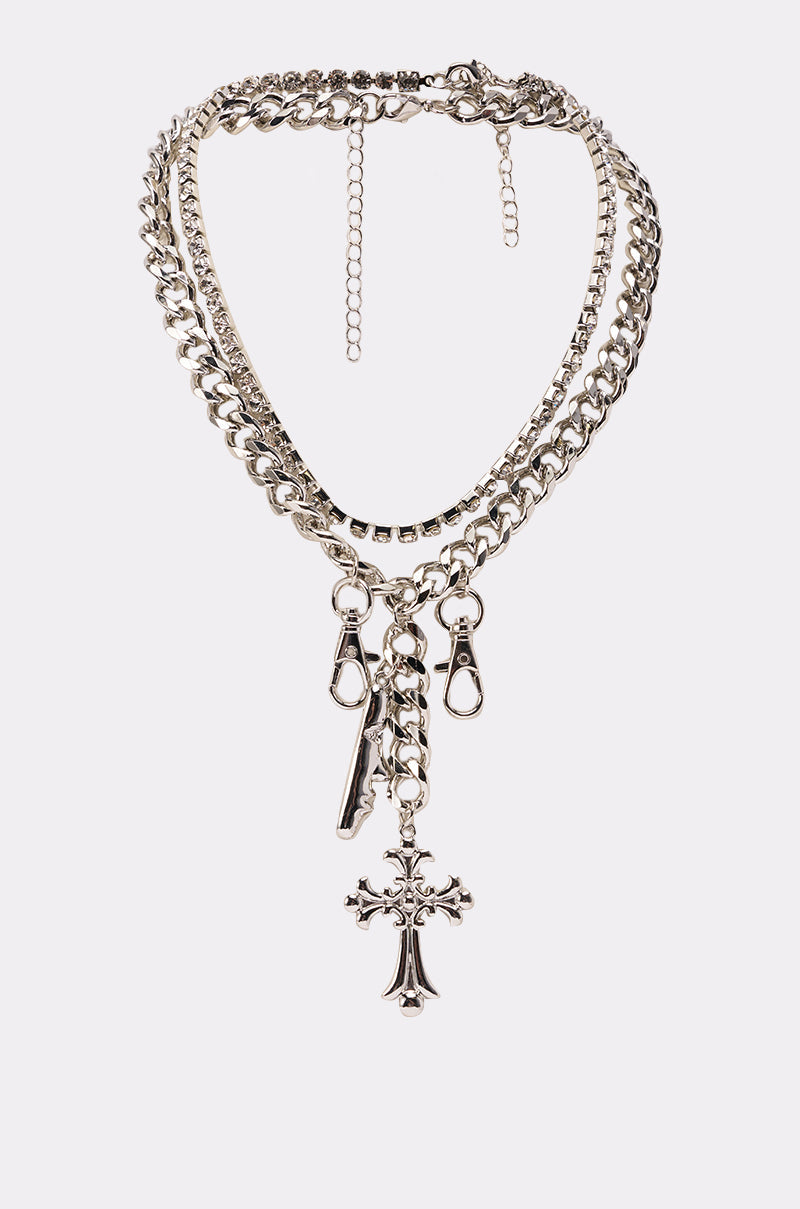 The ALL I SEE IS CHROME NECKLACE is a layered silver cuban chain with chunky links, a cross and rectangular bar pendant, plus two lobster clasps, shown on a plain white background. 0