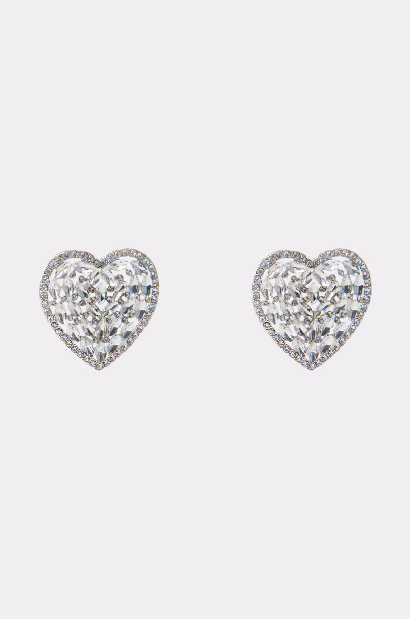 The ALL MY HEART EARRING IN SILVER features sparkling, heart-shaped rhinestone studs with clear faceted stones—an ideal bridal accessory displayed on a plain white background.
