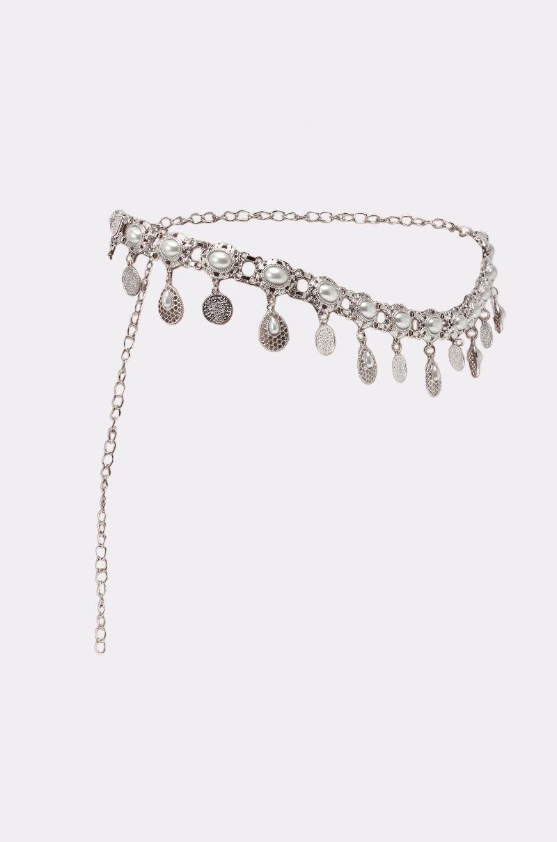 The ROCK YA BODY CHAIN BELT is a silver vintage-inspired accessory with intricate oval charms and dangling coin-like pendants, adding a boho-chic touch against a white background. 2