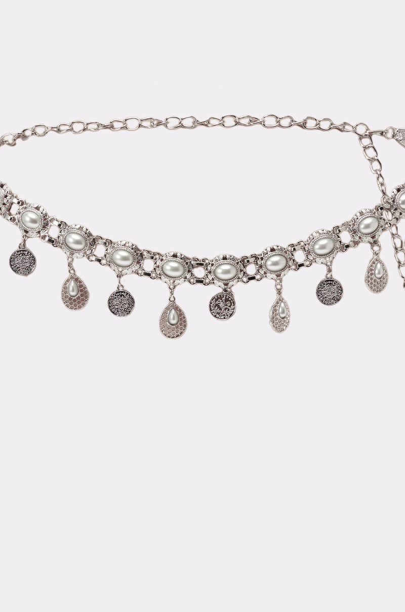 The ROCK YA BODY CHAIN BELT is a vintage-inspired silver chain with oval pearls, detailed filigree, and alternating round and teardrop dangling charms for a unique look. 3