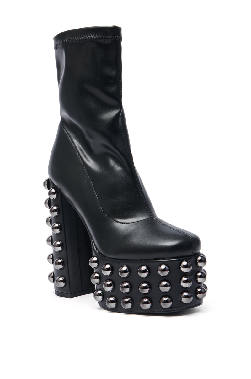 The AZALEA WANG AKITO BLACK GUN METAL STUDDED PLATFORM BOOTIE is a black, ankle-high bootie with a chunky high heel, detailed with shiny gun metal studs on the heel and platform.