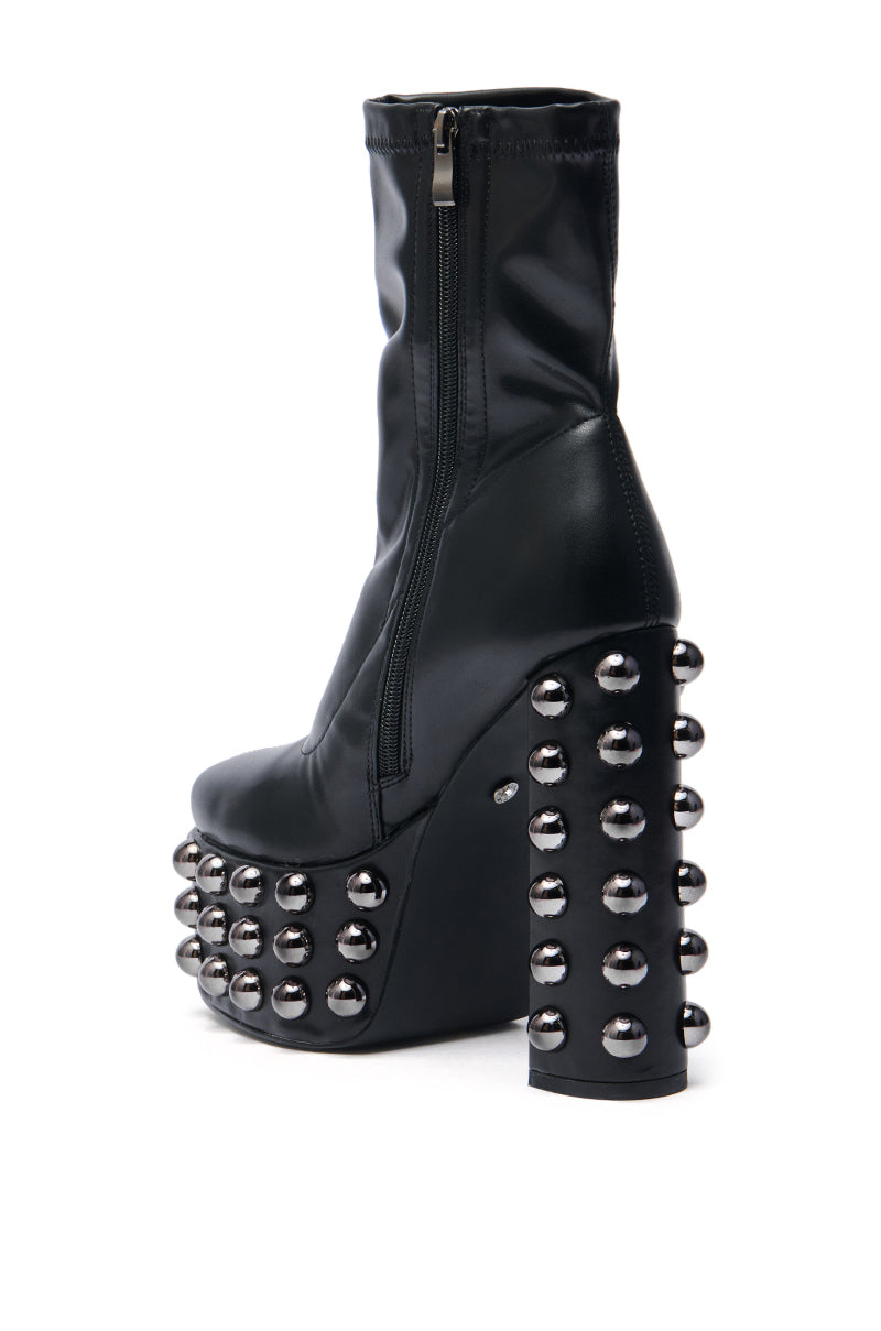 The AZALEA WANG AKITO BLACK GUN METAL STUDDED PLATFORM BOOTIE features a faux leather design with a side zipper and bold gun metal studs on the heel and platform for an edgy look.