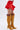 The lower half of a person is shown against a white background, wearing the JANEY MICRO MINI RUFFLE SKIRT IN RED with an adjustable waist and mustard yellow lace-up, over-the-knee heeled boots.