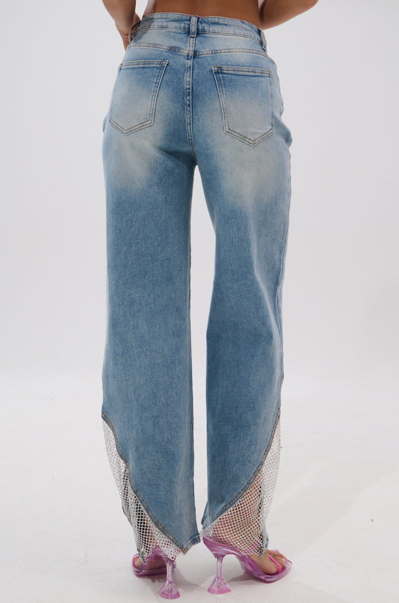 A person shown from the back against a plain white background wears BLING BLING RELAXED DENIM featuring sheer mesh ankle panels, paired with pink heeled sandals. 4