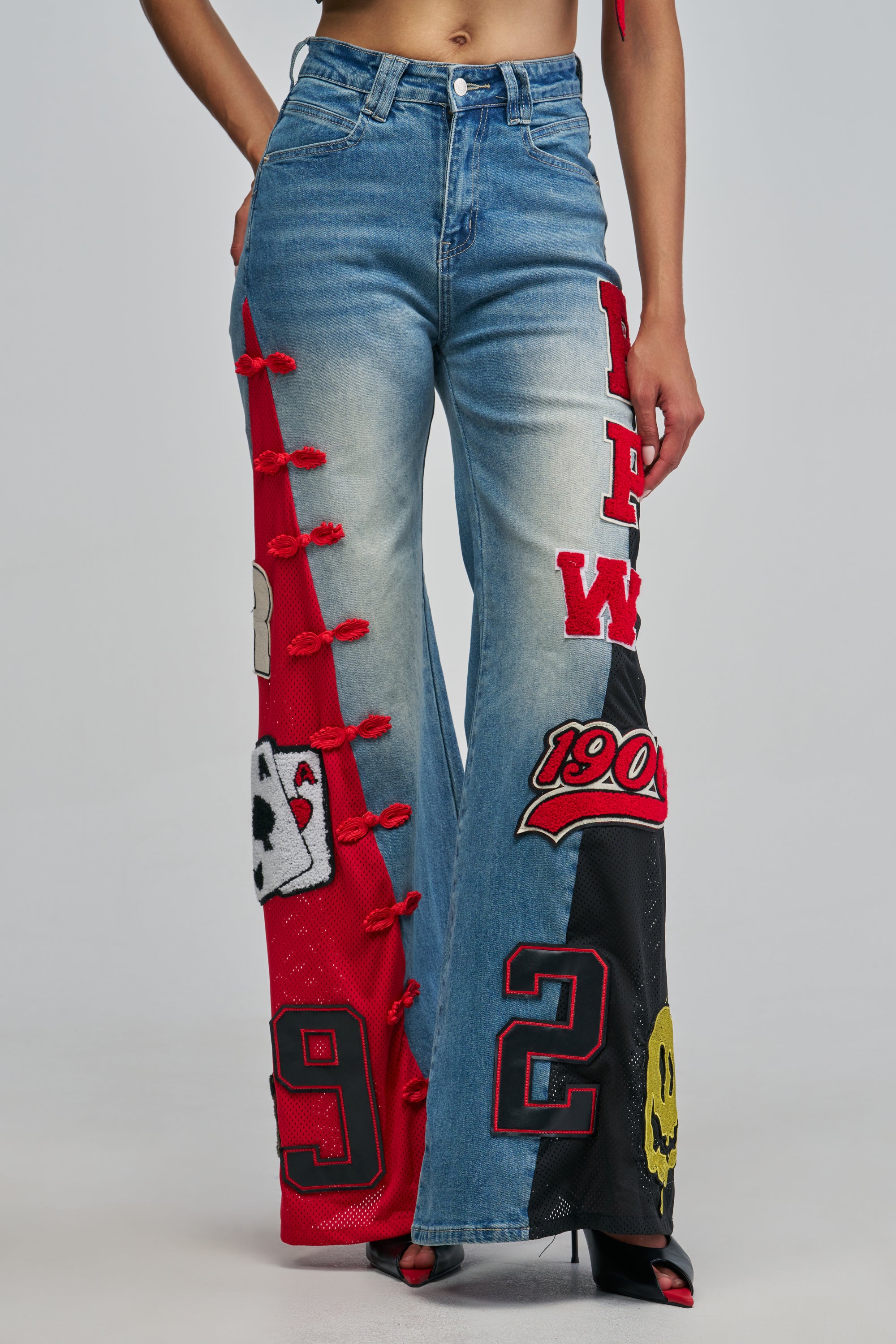 IN YOUR DREAMS PATCHWORK DENIM light blue wide-leg jeans featuring red and black mesh panels, embroidered patches, and red decorative frog closures.
