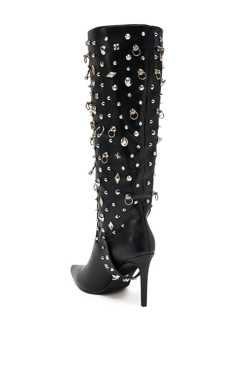 The AZALEA WANG AKRISTA Black Hardware Embellished Stiletto Knee High Boot features faux leather, silver studs, gems, and charms, shown against a white background.