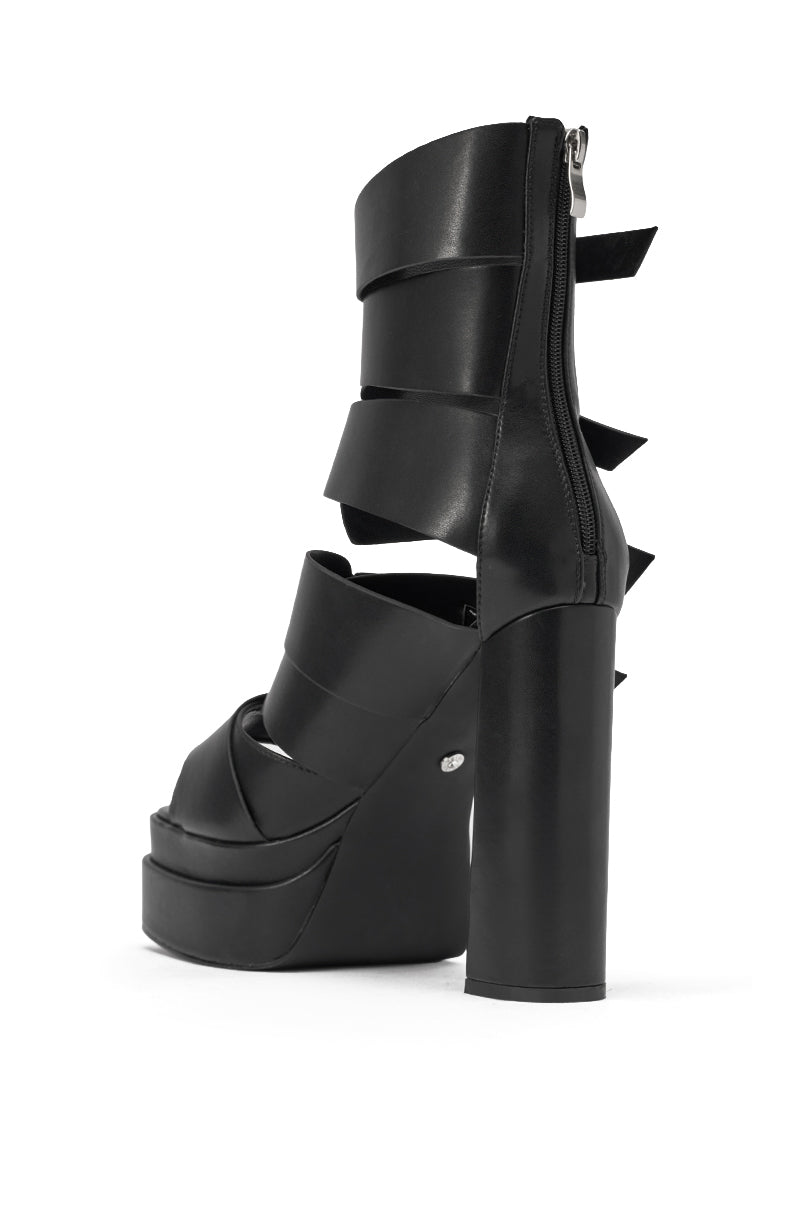 The AKIRA Gold Alberic Black Chunky Platform Sandal features wide layered straps, a back zipper closure, thick block heel, open toe, and chic faux leather design. 4
