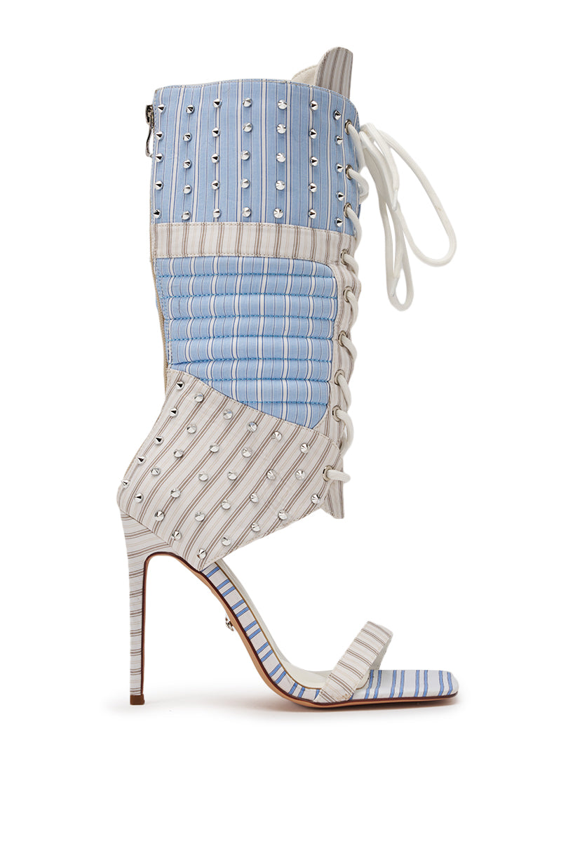 Step out for fashion week in the AKIRA GOLD ALBERTO BLUE STRIPE PATTERN GLADIATOR STILETO, a modern lace-up sandal with blue and white stripes, silver studs, quilted padding, and a unique structured design. 3
