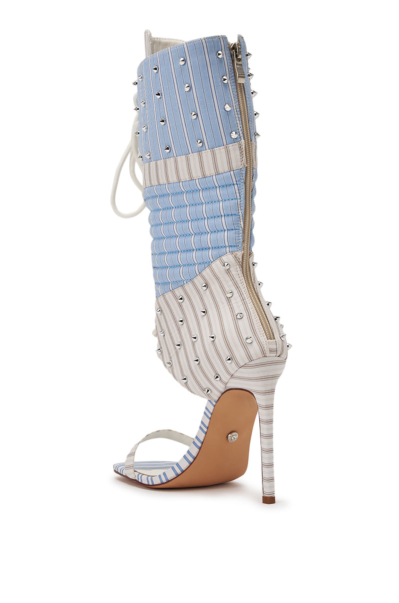The AKIRA GOLD ALBERTO BLUE STRIPE PATTERN GLADIATOR STILETTO is a bold mid-calf sandal with blue and white stripes, quilted texture, silver studs, an open toe, high heel, and side zipper for standout style. 5