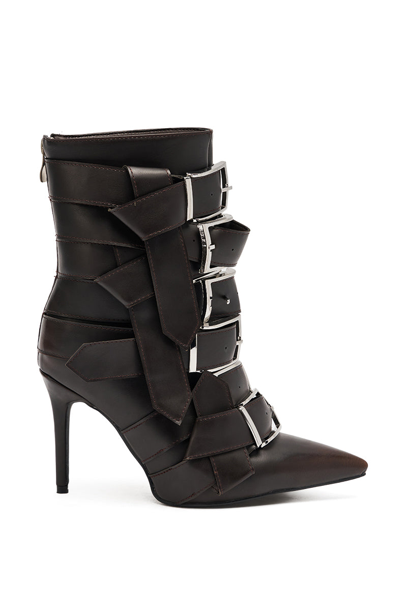 The AZALEA WANG ALCETAS CHOCOLATE STILETTO BOOTIE WITH BUCKLES features a pointed toe, multiple wide straps with large silver buckles on the front and side, plus a back zipper closure for easy wear. 3