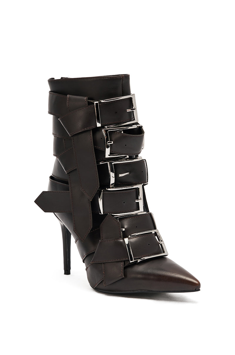 The AZALEA WANG ALCETAS Chocolate Stiletto Bootie features a high heel, pointed toe, dark brown leather, four wide silver-buckled straps, and oversized decorative side bows. 4