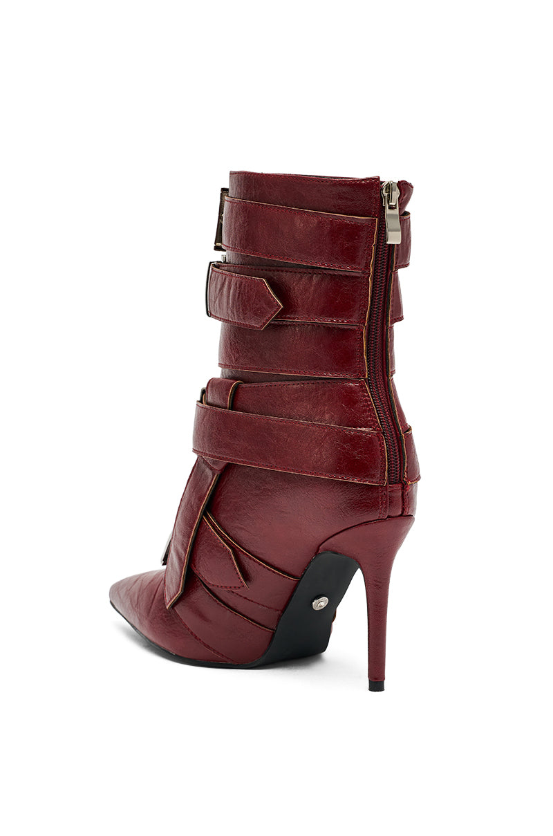 The AZALEA WANG ALCETAS Red Stiletto Bootie features textured dark red leather, multiple straps with buckles, a side zipper, and a pointed toe. Shown against a white background. 5