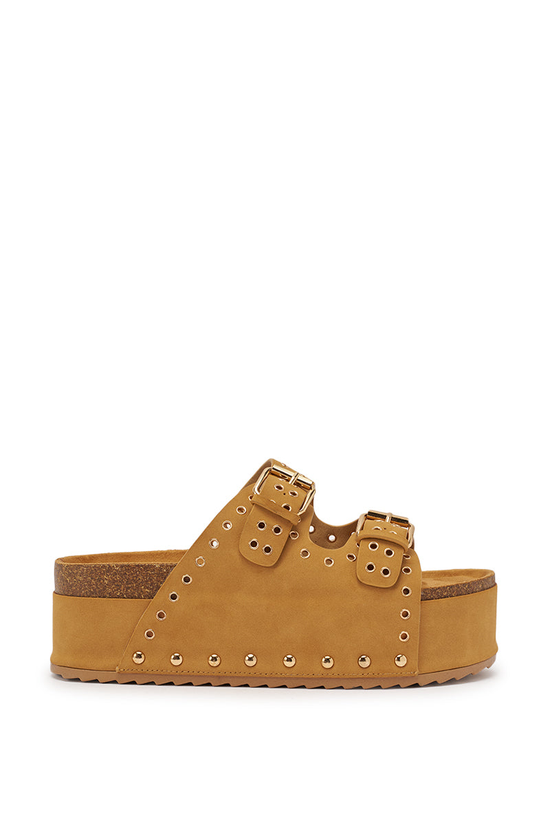 The AZALEA WANG ALGEDI TAN PLATFORM SANDAL features faux suede, two adjustable buckle straps, gold rivet accents, and a cork-like wedge sole, displayed in side profile on a white background. 4