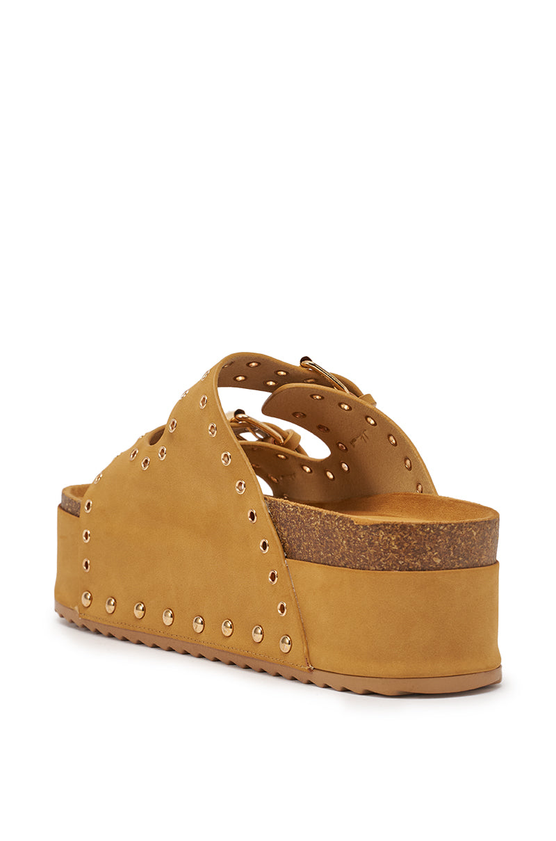 The AZALEA WANG ALGEDI TAN PLATFORM SANDAL features faux suede, a chunky platform sole, gold studs, grommet-detailed cut-out straps, and is shown from the back. 6