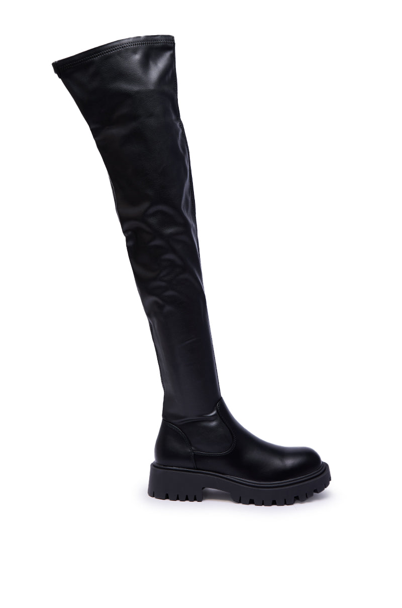 The AZALEA WANG ALINAFE Black Over the Knee Stretch PU Boot, featuring shiny faux leather and a chunky heel, is displayed in profile against a white background.