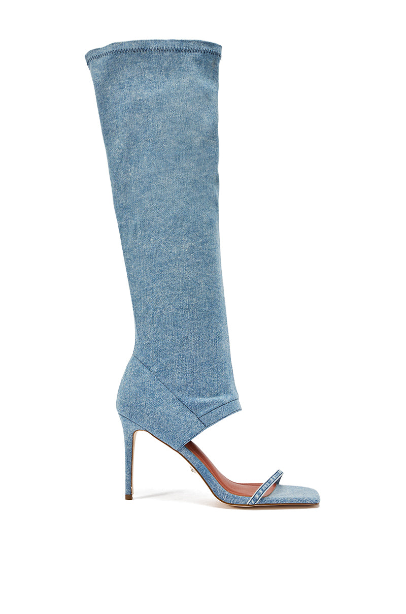 The AZALEA WANG ALISHAS DENIM GLADIATOR STILETTO SANDAL is a high-heeled, open-toe denim boot with a single toe strap and tall, slouchy knee-high shaft, perfect for adding bold style to any outfit.