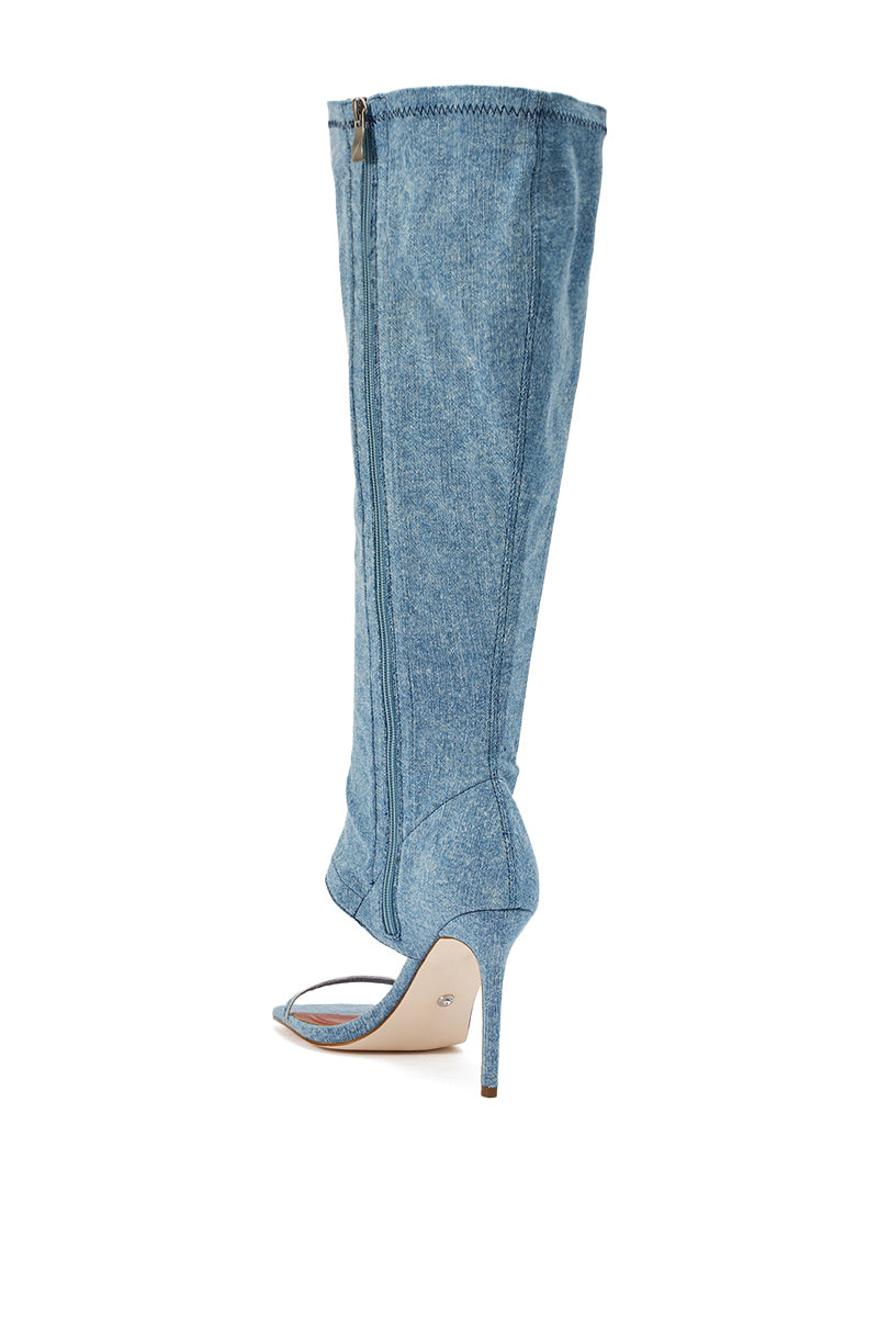 The AZALEA WANG ALISHAS DENIM GLADIATOR STILETTO SANDAL is a light blue, knee-high open-toe shoe featuring a stiletto heel, light denim fabric, and an easy-access side zipper.