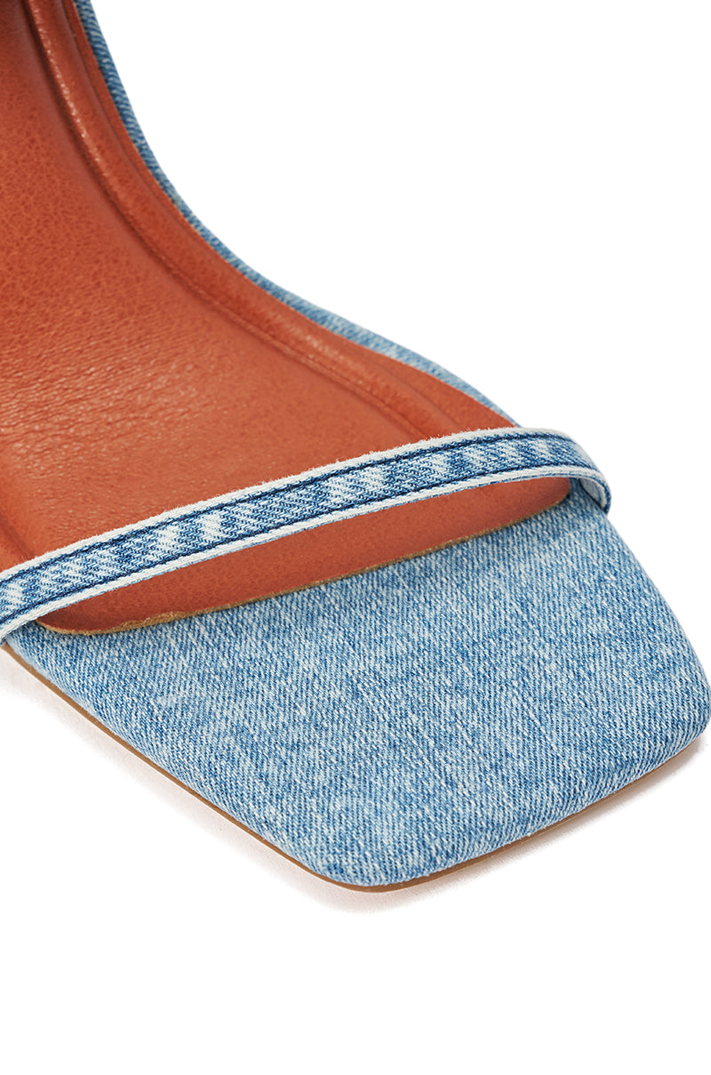 Close-up of the AZALEA WANG ALISHAS DENIM GLADIATOR STILETTO SANDAL, showcasing its square toe, light blue denim straps and sole, plus a brown insole—channeling the trendy look of denim knee-high boots.