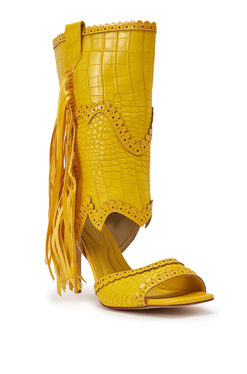 The AZALEA WANG ALPHONSE YELLOW OPEN TOE SANDAL boasts a high heel, bright yellow crocodile texture, scalloped edges, and long fringe for a bold boho-chic, western-inspired look. 5