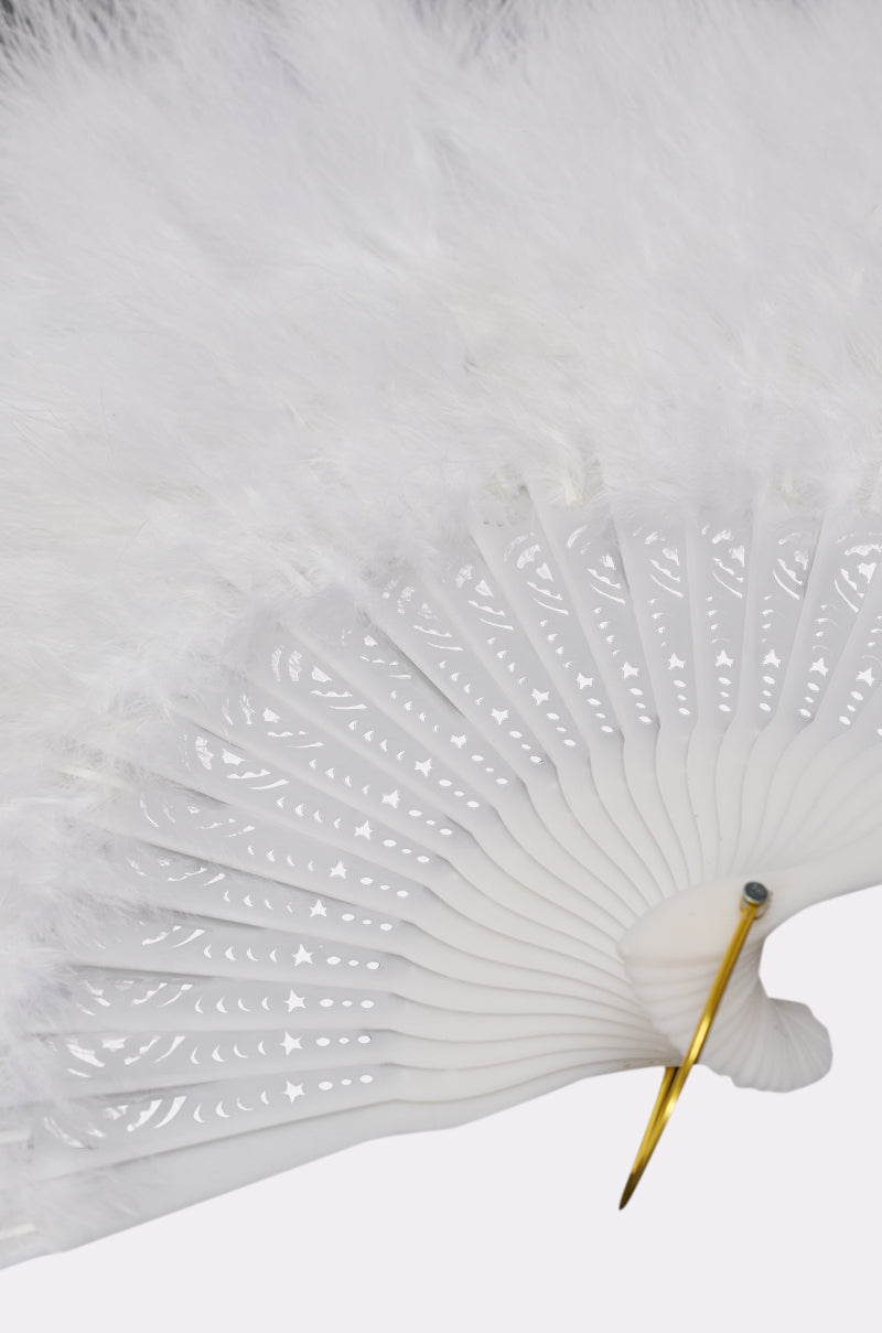 A close-up of the ANGELIC WHITE FEATHER FAN shows its elegant white feathers, delicate trim, intricate cut-out spokes, and gold-colored rivet—perfect as a bridal fan or festival accessory. 4