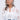 A pretty lady with long, wavy gray hair wears a sheer white floral blouse over a white top and blue jeans. She accessorizes with PRETTY LADY EARRING—flower-shaped earrings with rhinestone centers—and smiles softly to the side.