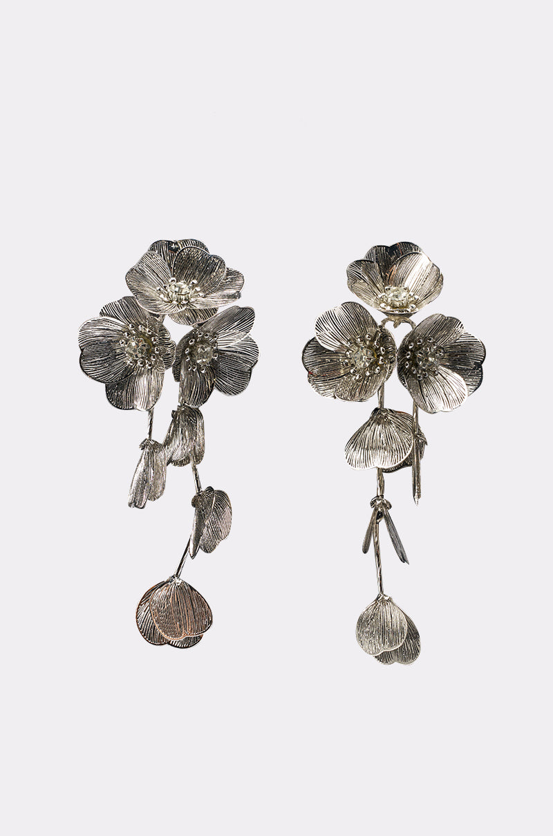 The PRETTY LADY EARRING features silver floral drops with layered petals and dangling buds, crafted to resemble blooming flowers. These elegant earrings offer a nature-inspired look, perfect for any occasion.