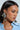 A woman with long dark hair wears PRETTY LADY EARRING featuring rhinestone centers and a light blue denim shirt. Her makeup is subtle as she gazes to the side against a plain background.