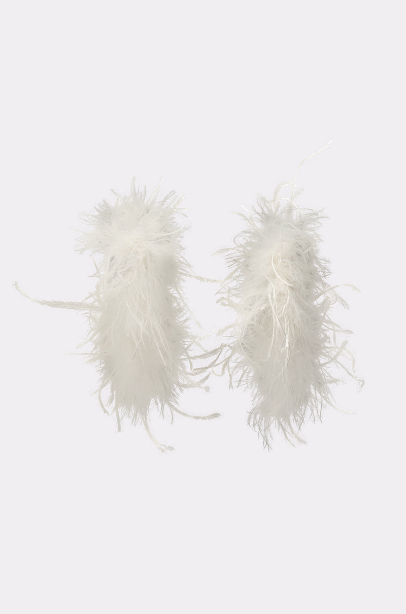 The LET ME FLY HOOP EARRING features two fluffy white feather hoops with a soft, airy texture, evoking an angelic touch and elegantly displayed on a plain light background. 3