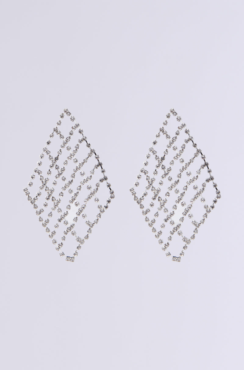 The "DANCE THE NIGHT AWAY" earrings elegantly dangle with a diamond-shaped lattice design, showcasing rhinestone links made of small, sparkling silver crystals, set against a plain white background.